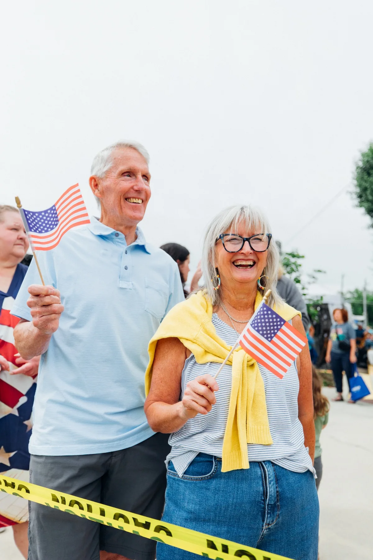 Couple holding American flags at a community event in Ringgold, Georgia.