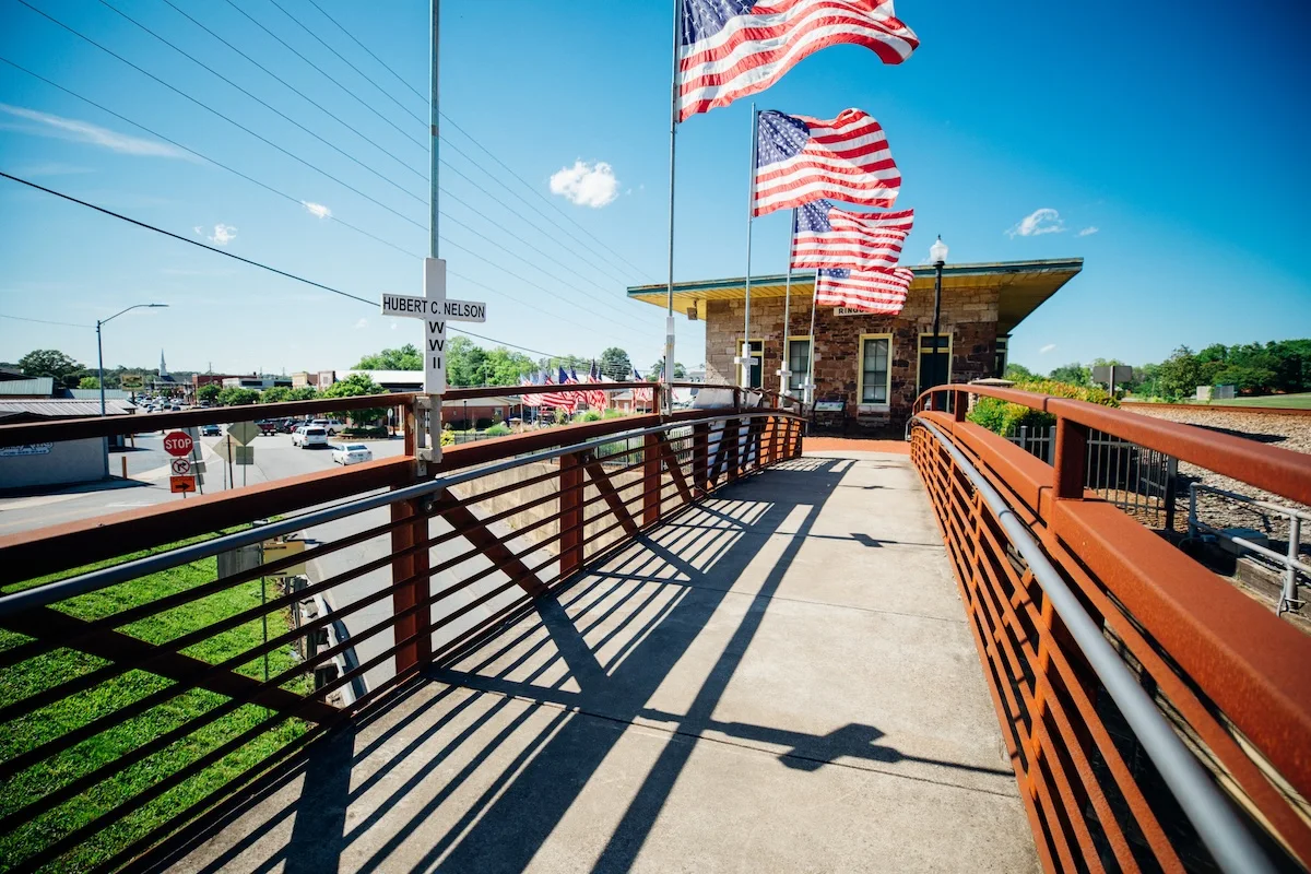 Pedestrian bridge with American flags overlooking downtown Ringgold, Georgia